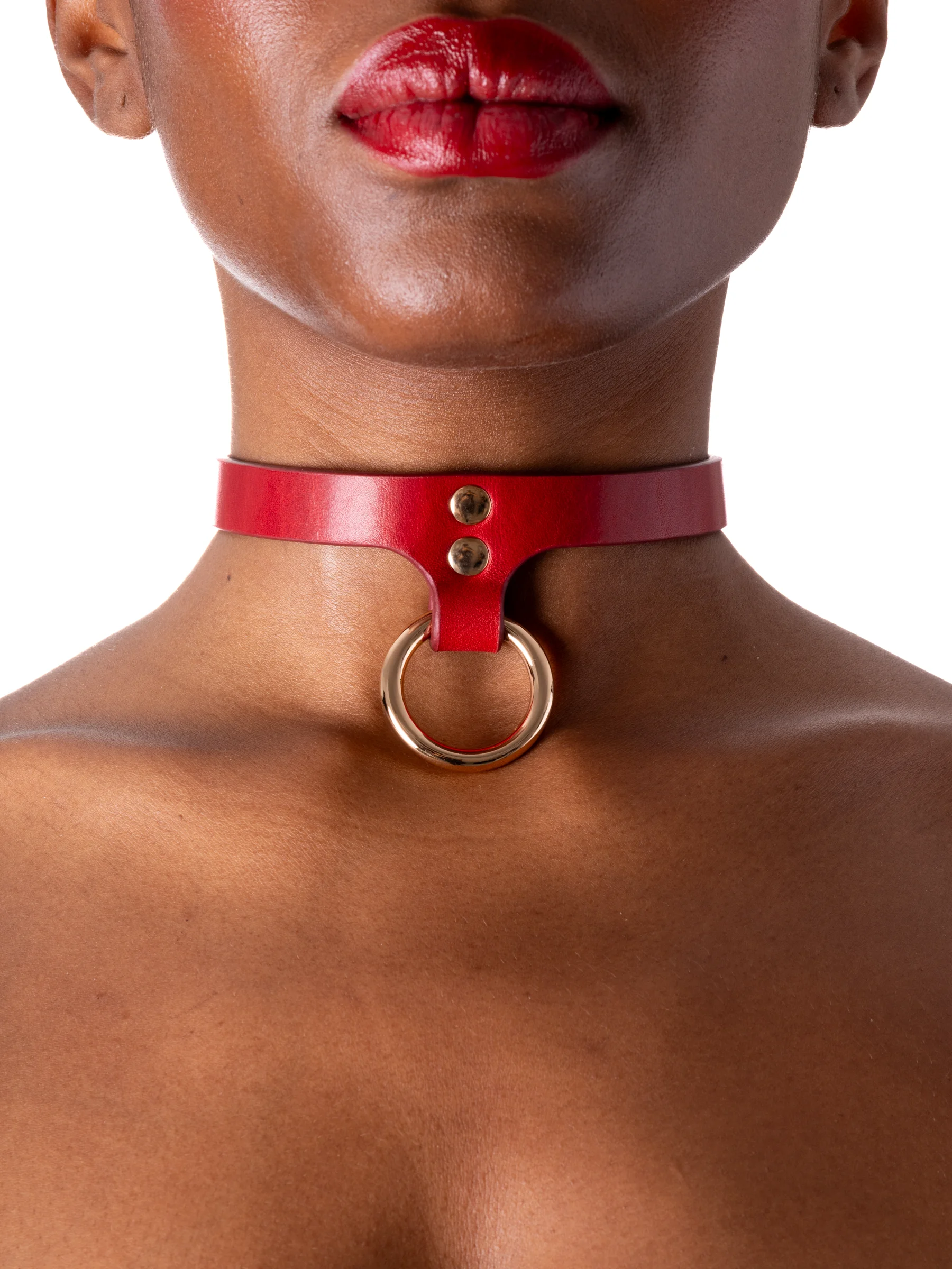 Woman is showing off a thin BDSM collar with a gold ring attached